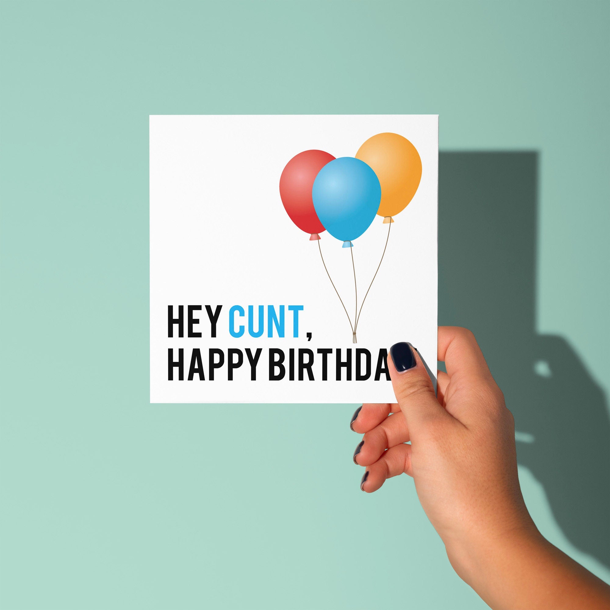 Hand holding a card with colorful balloons and 'Happy Birthday' text on a light green background